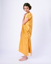 Load image into Gallery viewer, gold colored satin maxi tshirt dress with side slit on woman
