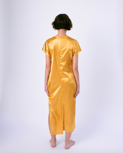 back of gold colored satin maxi tshirt dress with side slit on woman