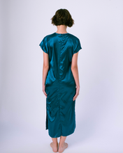 Load image into Gallery viewer, back view of blue satin maxi tshirt dress with side slit on woman 
