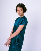 Load image into Gallery viewer, side view of blue satin maxi tshirt dress with side slit on woman 
