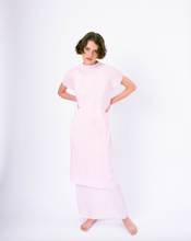 Load image into Gallery viewer, Front of pink pleated tiered maxi dress with mock neck and short sleeves on woman 
