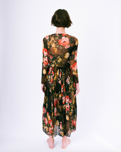 Back of floral print brown mesh overlay a-line dress with long sleeves over attached satin slip on woman