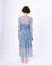 Load image into Gallery viewer, Back view of long sleeve blue and white floral a-line dress with mesh overlay over slip dress on woman
