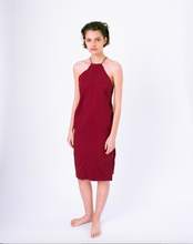 Load image into Gallery viewer, Front of dark red halter dress with open back &amp; crossed straps on woman
